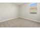 Well-lit bedroom featuring neutral carpet, one window, and light gray walls at 4820 N 177Th Dr, Goodyear, AZ 85395