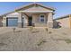 Single story home with a covered front porch, rock landscaping and a blue garage door at 4820 N 177Th Dr, Goodyear, AZ 85395