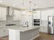 Modern kitchen featuring white cabinets, stainless steel appliances, and a kitchen island at 4820 N 177Th Dr, Goodyear, AZ 85395