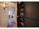 Well-lit hallway with linen closet and view into the kitchen at 7625 E Camelback Rd # B116, Scottsdale, AZ 85251