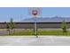 Exterior shot of community basketball court with a backdrop of scenic mountains at 8657 W Warner St, Tolleson, AZ 85353