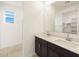 A modern bathroom featuring a double sink vanity and tiled shower space at 8657 W Warner St, Tolleson, AZ 85353