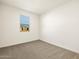 A simple bedroom with neutral carpet and natural light at 8657 W Warner St, Tolleson, AZ 85353