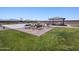 Green community area with a basketball court, shade structure, and park benches on a sunny day at 8657 W Warner St, Tolleson, AZ 85353