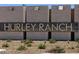 Close up of Hurley Ranch community sign with stone block backdrop and desert landscaping at 8657 W Warner St, Tolleson, AZ 85353