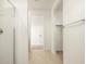 Hallway with tile flooring leading to a bedroom with neutral carpet and a modern bathroom at 8657 W Warner St, Tolleson, AZ 85353