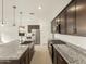 Well-lit kitchen featuring dark cabinets, stainless steel appliances and a large island with granite counters at 8657 W Warner St, Tolleson, AZ 85353