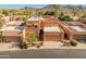 Aerial view of a two-story home with a tile roof and a mountain backdrop at 10653 N 10Th Pl, Phoenix, AZ 85020