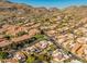 Aerial view of house and surrounding neighborhood, nestled in a mountainous area at 10653 N 10Th Pl, Phoenix, AZ 85020