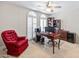 Home office with built-in shelving and red armchair at 10653 N 10Th Pl, Phoenix, AZ 85020