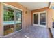 Stone patio with sliding glass doors leading to the pool at 10653 N 10Th Pl, Phoenix, AZ 85020