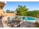 Relaxing kidney-shaped pool with patio furniture and lush landscaping at 10653 N 10Th Pl, Phoenix, AZ 85020