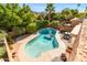 Inviting kidney-shaped pool with patio furniture, surrounded by lush landscaping at 10653 N 10Th Pl, Phoenix, AZ 85020