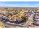 Aerial view of a residential area featuring houses and a green golf course at 22821 S 212Th St, Queen Creek, AZ 85142