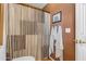 Bathroom with shower, striped curtain, and wood-look tile at 22821 S 212Th St, Queen Creek, AZ 85142