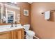 Bathroom with single vanity, toilet and wood cabinets at 22821 S 212Th St, Queen Creek, AZ 85142