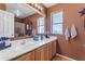 Bathroom with double vanity, wood cabinets, and tile floors at 22821 S 212Th St, Queen Creek, AZ 85142