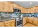 Kitchen with stainless steel appliances and wood cabinetry at 22821 S 212Th St, Queen Creek, AZ 85142
