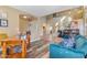 Living room features a teal couch, wood floors and open layout at 22821 S 212Th St, Queen Creek, AZ 85142
