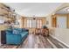 Home office with teal couch, wood floors and large windows at 22821 S 212Th St, Queen Creek, AZ 85142