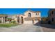 Two-story house with a three-car garage and a neat lawn at 25667 N 68Th Ln, Peoria, AZ 85383