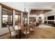 Bright dining area with a rustic wood table and large windows offering scenic views at 33296 N Vanishing Trl, Scottsdale, AZ 85266