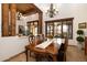 Elegant dining room with a wooden table, decorative chandeliers, and large windows at 33296 N Vanishing Trl, Scottsdale, AZ 85266