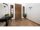 Inviting entryway featuring a decorative wood door, sconces, and tile flooring at 33296 N Vanishing Trl, Scottsdale, AZ 85266