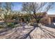 Expansive front yard featuring lush desert landscaping, a brick driveway, and a covered entryway at 33296 N Vanishing Trl, Scottsdale, AZ 85266