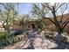 Stunning desert landscaping and a brick path lead to a welcoming entry of the house at 33296 N Vanishing Trl, Scottsdale, AZ 85266
