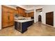 Open kitchen with custom wood cabinets, granite countertops, and a wine fridge in the island at 33296 N Vanishing Trl, Scottsdale, AZ 85266