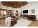 Cozy living room featuring a fireplace, comfortable seating, and a decorative ceiling at 33296 N Vanishing Trl, Scottsdale, AZ 85266