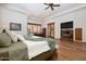 Comfortable main bedroom with a fireplace, media center, and access to an outdoor area at 33296 N Vanishing Trl, Scottsdale, AZ 85266