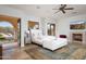 Main bedroom with fireplace, mountain views, and access to patio at 4308 N Sage Creek Cir, Mesa, AZ 85207