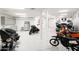 Large garage with workshop area, motorcycles, and boat at 4308 N Sage Creek Cir, Mesa, AZ 85207