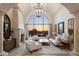 Elegant living area with a large window, fireplace, and high ceilings at 4308 N Sage Creek Cir, Mesa, AZ 85207