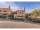 Tan stucco building exterior, two-story, with arched windows at 13227 N Mimosa Dr # 109, Fountain Hills, AZ 85268