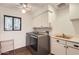 Well-equipped laundry room with washer, dryer, sink, and cabinets at 13227 N Mimosa Dr # 109, Fountain Hills, AZ 85268