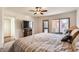 Spacious main bedroom with large TV and private balcony access at 13227 N Mimosa Dr # 109, Fountain Hills, AZ 85268