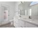 Bright bathroom with double sinks,white cabinets, and a shower at 15936 W Latham St, Goodyear, AZ 85338