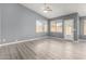 Bright living room with wood-look floors and ceiling fan at 15936 W Latham St, Goodyear, AZ 85338