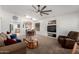 Bright living room showcasing neutral carpeting, dining area, and a comfortable recliner at 2083 S 155Th Ln, Goodyear, AZ 85338