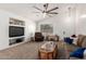 Inviting living room featuring a window, built-in shelving, and neutral carpeting at 2083 S 155Th Ln, Goodyear, AZ 85338