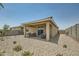 Backyard showcasing a covered patio, gravel landscaping, and potential for outdoor enjoyment at 24969 N 173Rd Ln, Surprise, AZ 85387