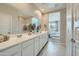 Bathroom featuring a double sink vanity and an open view to the main bedroom at 24969 N 173Rd Ln, Surprise, AZ 85387