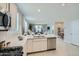 Well-lit kitchen with a view of the living area, a large island, and modern appliances at 24969 N 173Rd Ln, Surprise, AZ 85387