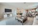 Spacious living room seamlessly connects to the dining area and kitchen, promoting an open concept design at 24969 N 173Rd Ln, Surprise, AZ 85387