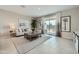 Comfortable living room featuring a neutral color palette, a patterned rug, and a sliding glass door at 24969 N 173Rd Ln, Surprise, AZ 85387