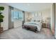 Bright main bedroom featuring a neutral color palette, plush carpet and a large window at 24969 N 173Rd Ln, Surprise, AZ 85387