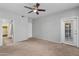 Large bedroom with carpeted floors, ceiling fan, and access to patio at 3302 N 7Th St # 226, Phoenix, AZ 85014